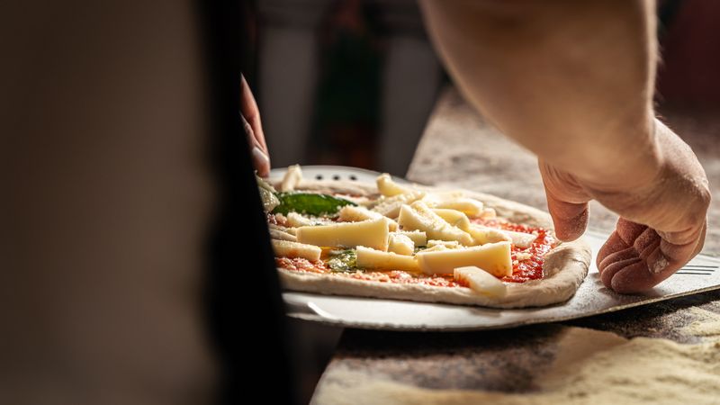 Green Lantern Pizza kitchen with fresh dough being prepared